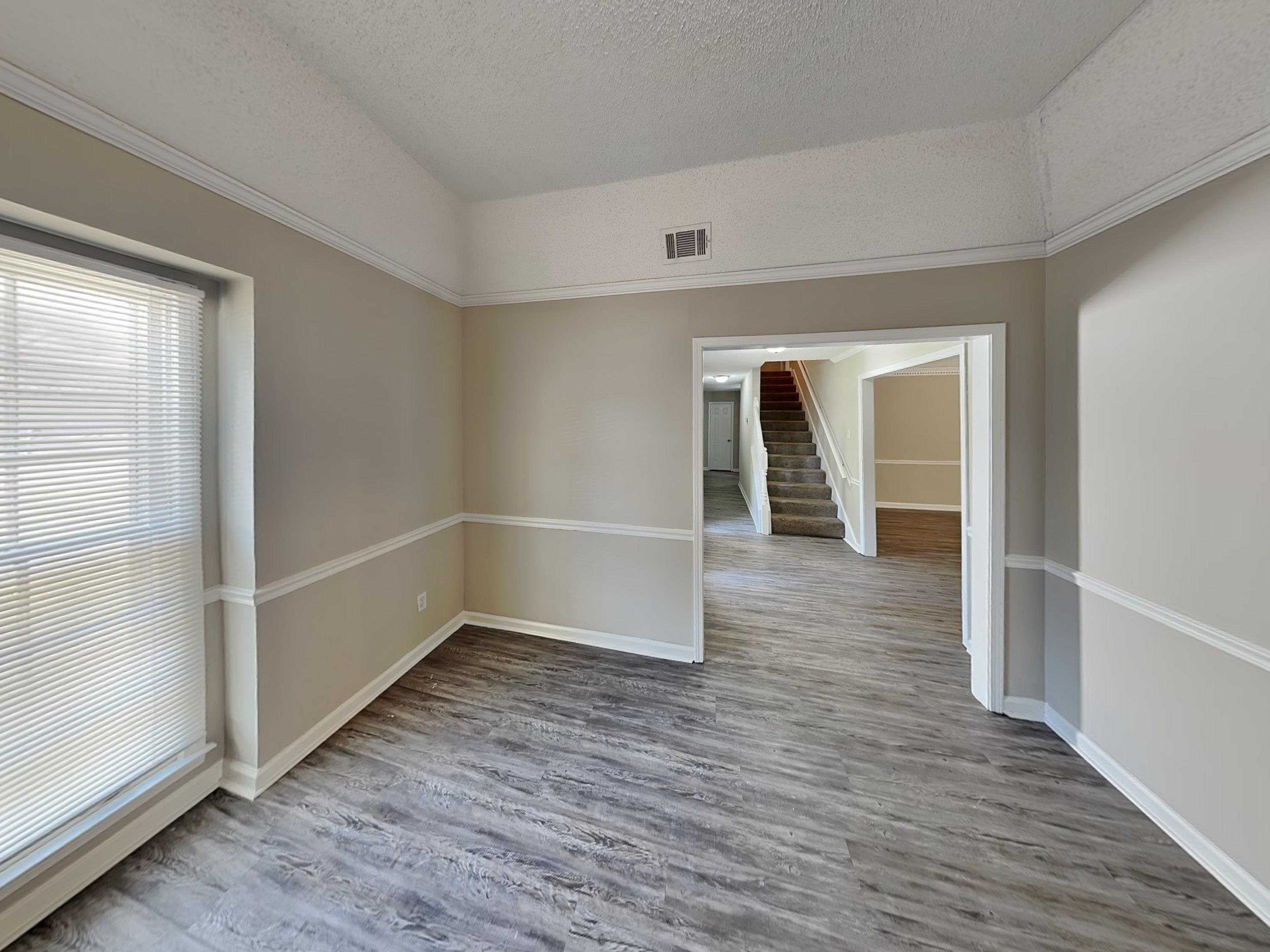 7041 Cutter Mill Road Memphis, TN 38141 - Photo 5 of 18 an empty room with wooden floor and white walls