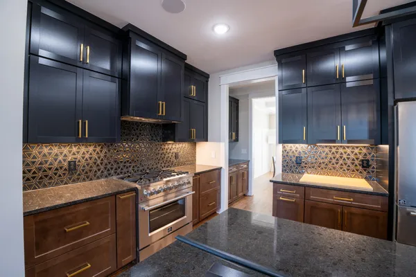 a kitchen with stainless steel appliances granite countertop a stove and a refrigerator