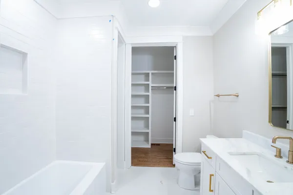 a bathroom with a sink a toilet and a bathtub