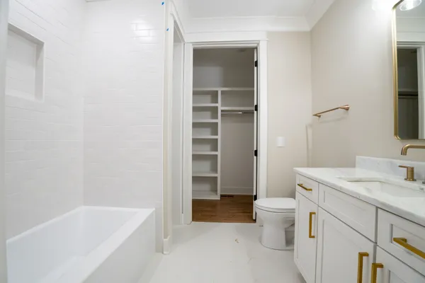 a bathroom with a toilet a sink and a mirror