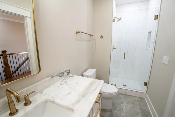 a bathroom with a sink toilet and shower