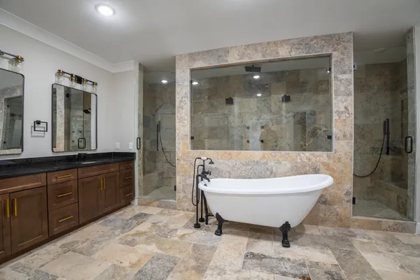 a bathroom with a tub sink and mirror