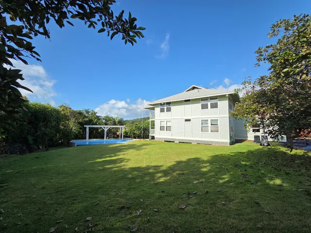 a kitchen with stainless steel appliances granite countertop a sink a stove and a refrigerator with wooden floor