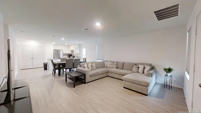 a living room with furniture and wooden floor