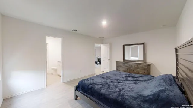 a bedroom with a bed and a dresser