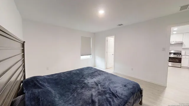 a bedroom with a bed and cabinets