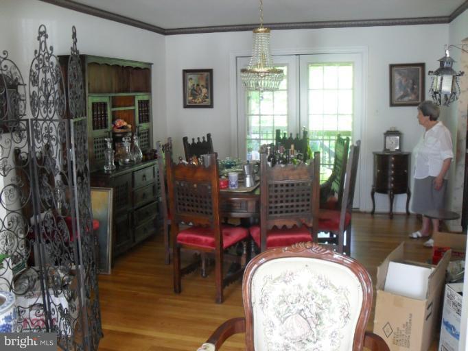 14309 Ansted Road Silver Spring, MD 20905 - Photo 2 of 17 a living room with furniture a window and a chandelier