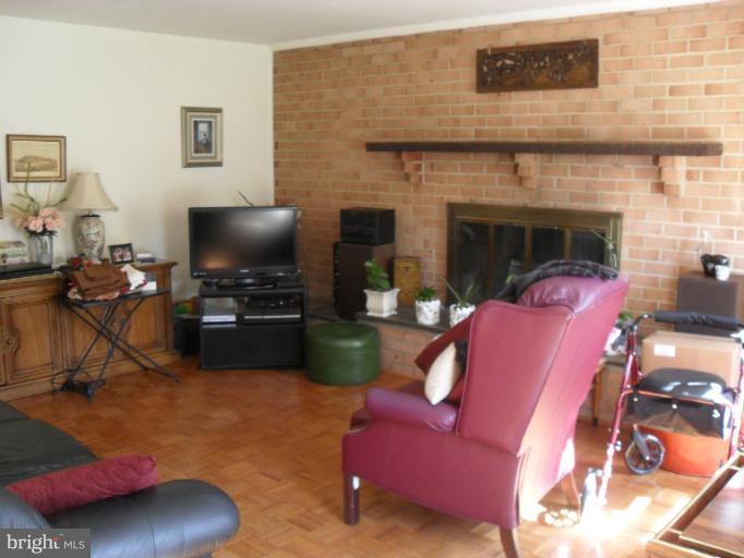14309 Ansted Road Silver Spring, MD 20905 - Photo 14 of 17 a living room with furniture and a flat screen tv