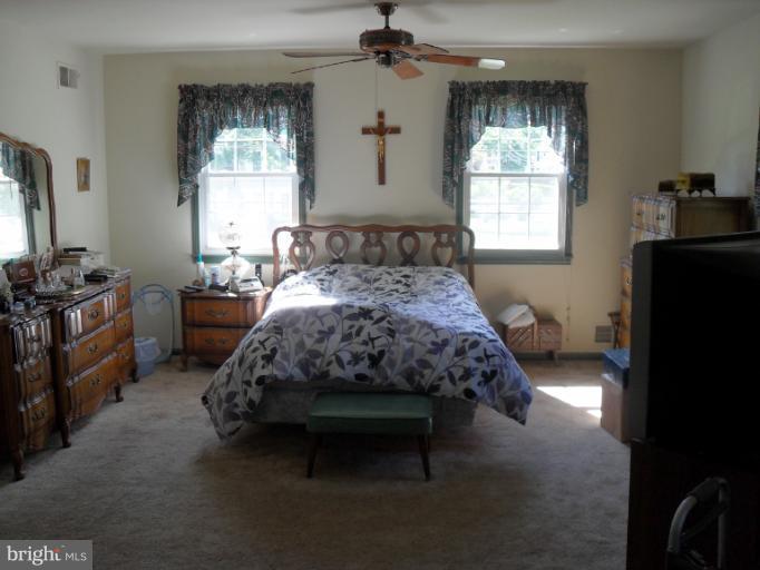 14309 Ansted Road Silver Spring, MD 20905 - Photo 17 of 17 a bedroom with a bed and a window in it