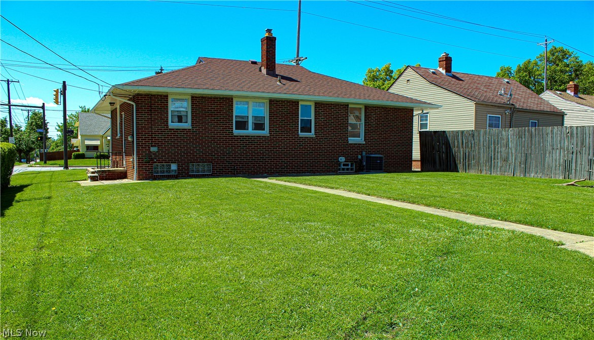 4495 Fulton Road Cleveland, OH 44144 - Photo 3 of 21 Back of house featuring a lawn
