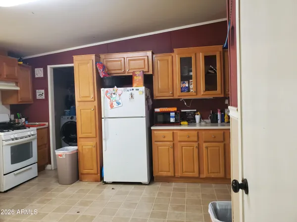 a kitchen with stainless steel appliances granite countertop a refrigerator a stove a sink and a microwave