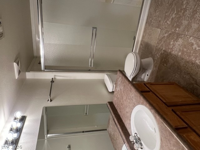 7255 West Sunset Road, Unit 1124 Las Vegas, NV 89113 - Photo 3 of 18 A classic vanity setup meets tile flooring in this functional bathroom.