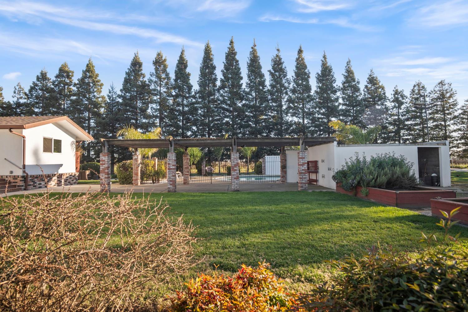 20201 Dustin Road Acampo, CA 95220 - Photo 13 of 16 a view of a house with garden and a trees