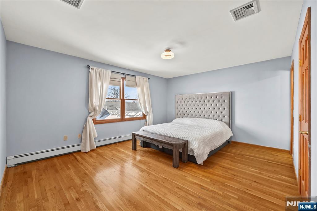 391 Taylor, Unit 2 Hackensack, NJ 07601 - Photo 13 of 15 a bedroom with a bed and a window
