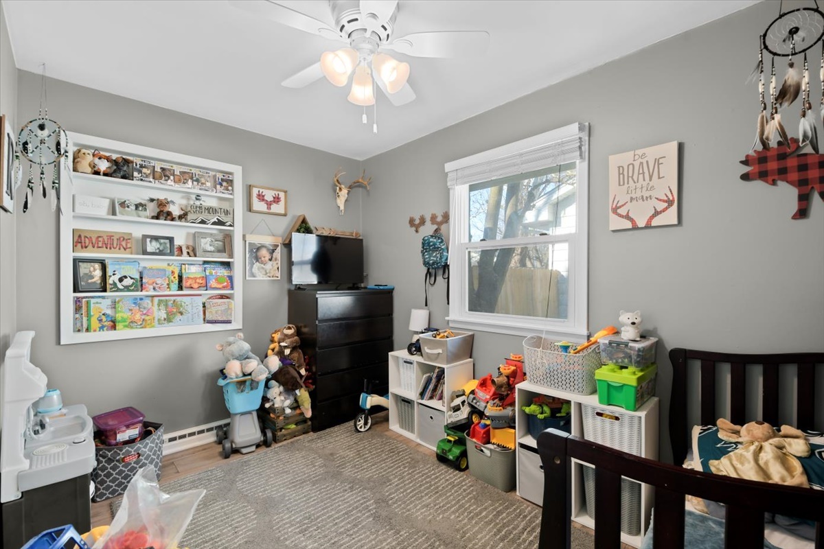 215 North 3rd Street Fisher, IL 61843 - Photo 11 of 17 a bedroom with furniture a chandelier and a window