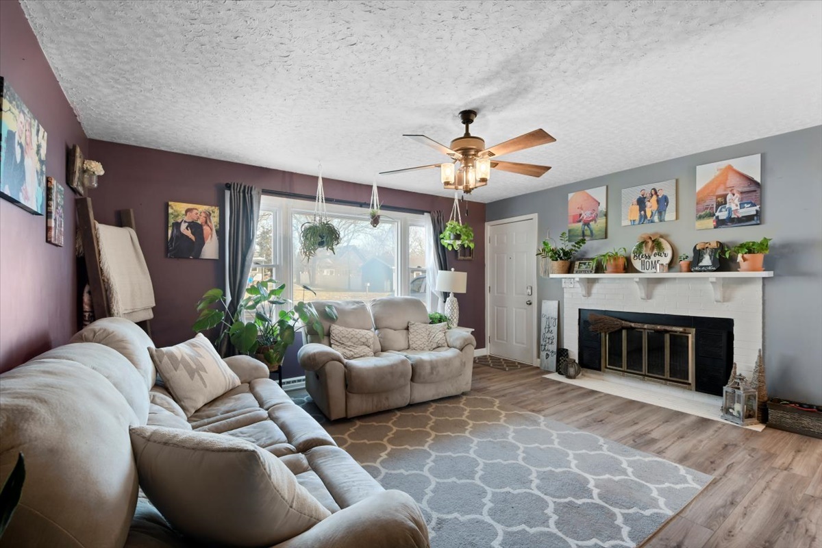 215 North 3rd Street Fisher, IL 61843 - Photo 2 of 17 a living room with furniture and a fireplace