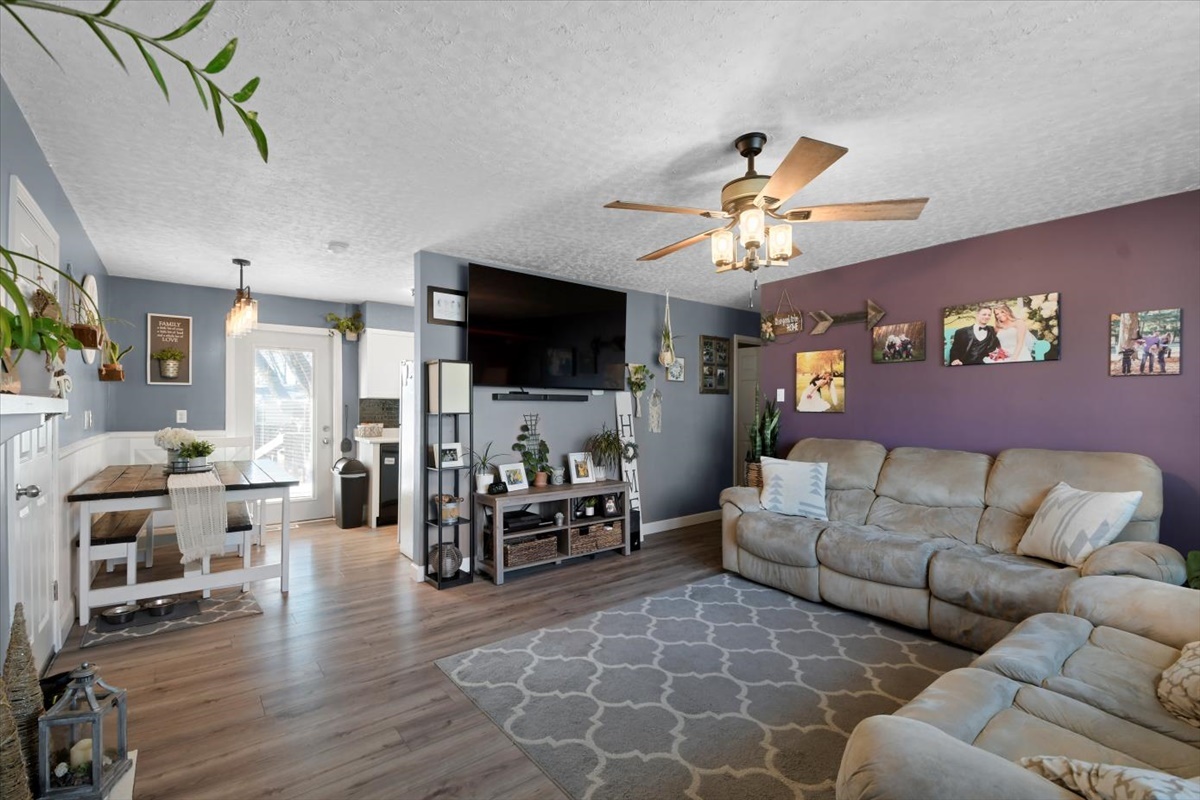 215 North 3rd Street Fisher, IL 61843 - Photo 3 of 17 a living room with furniture ceiling fan and a flat screen tv