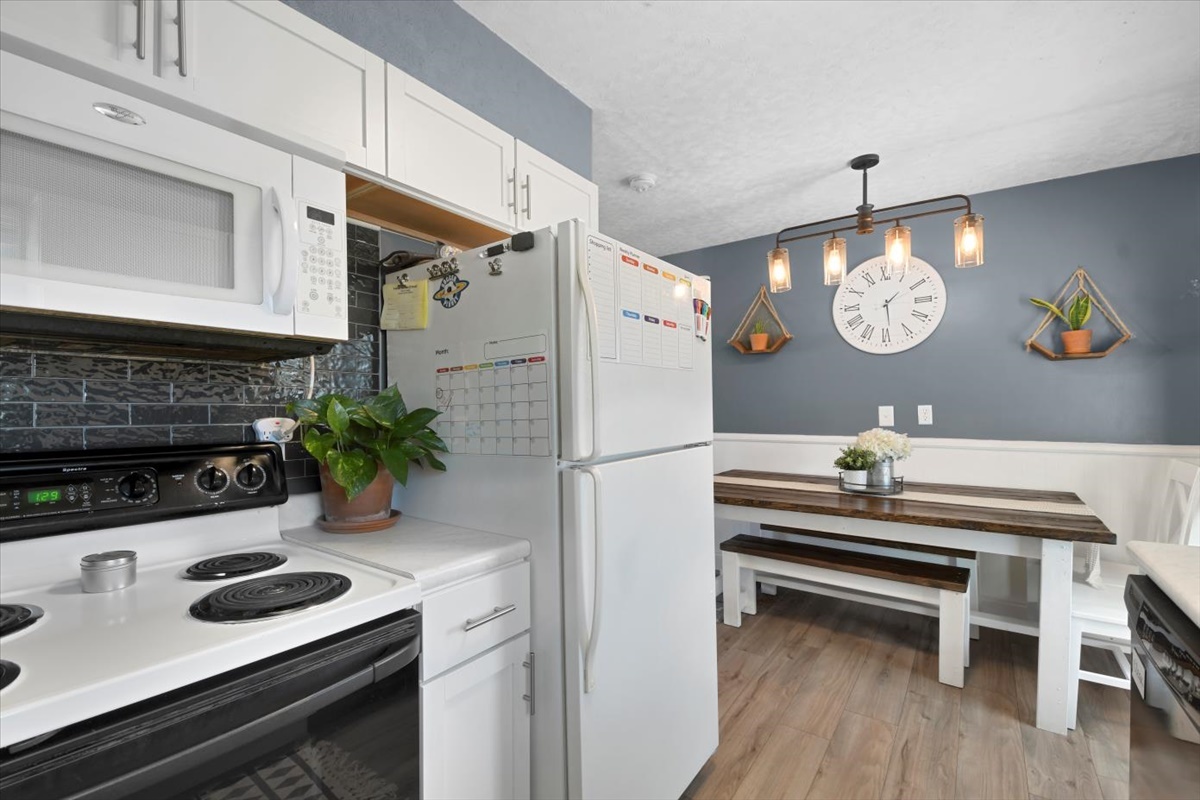 215 North 3rd Street Fisher, IL 61843 - Photo 6 of 17 a kitchen with a stove a refrigerator and a table