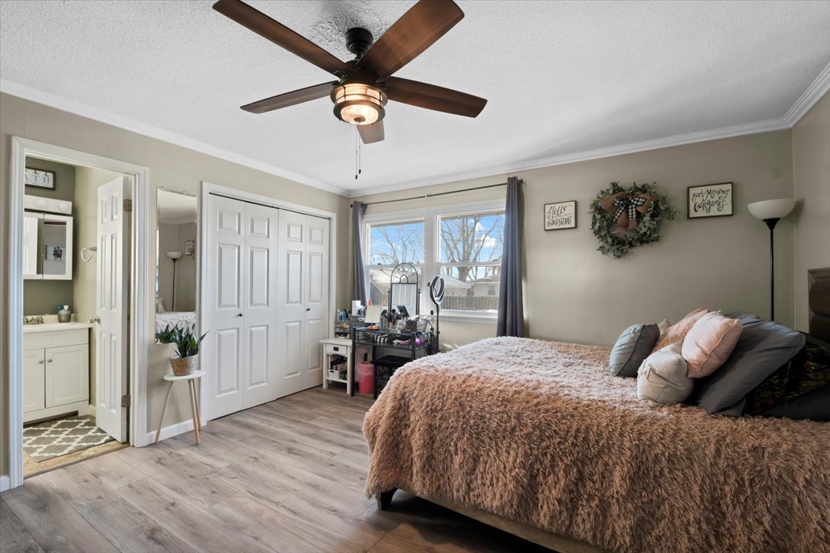 215 North 3rd Street Fisher, IL 61843 - Photo 9 of 17 a bedroom with a bed and a chandelier