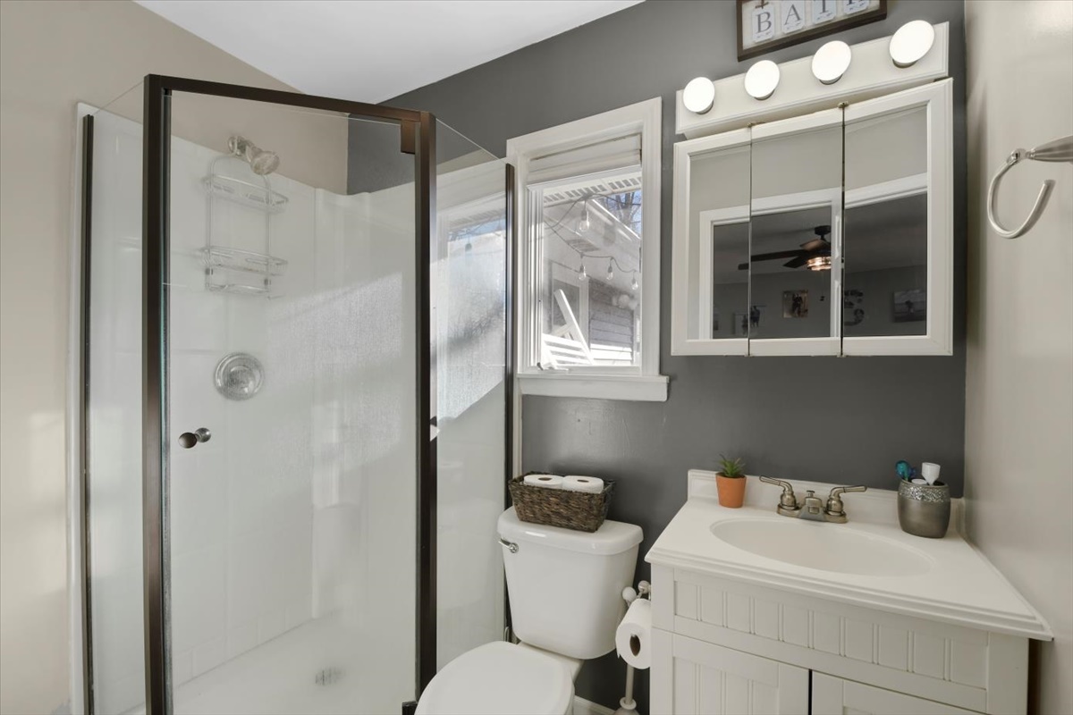 215 North 3rd Street Fisher, IL 61843 - Photo 10 of 17 a bathroom with a sink toilet and shower