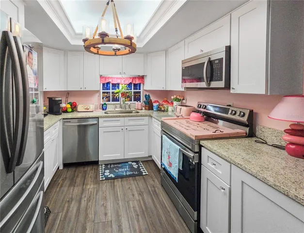 a kitchen with a sink stove and microwave