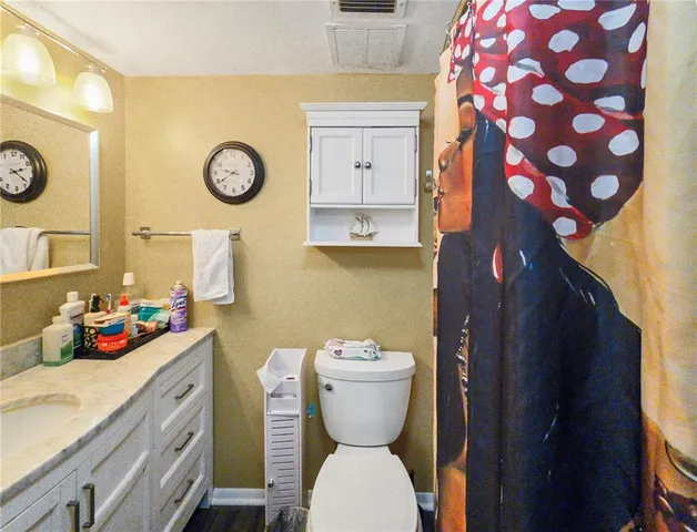 a bathroom with a toilet a sink and a mirror