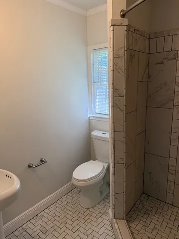 a bathroom with a toilet and a shower