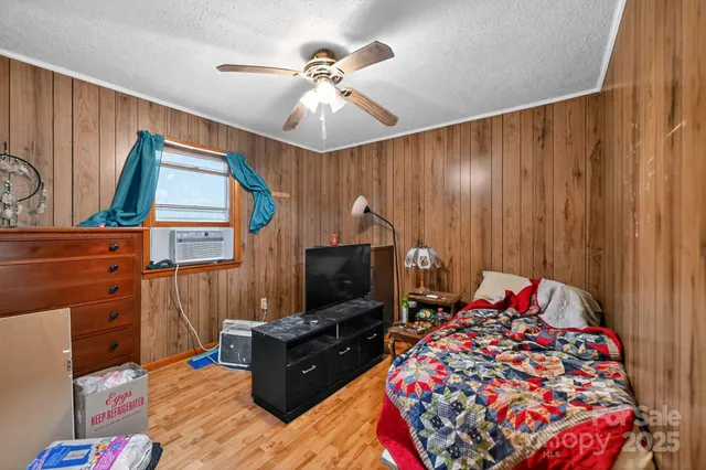 a bedroom with a bed and flat screen tv