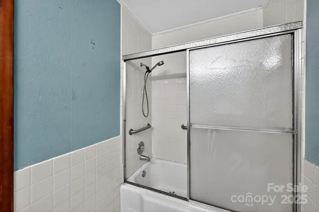 a bathroom with a glass shower door