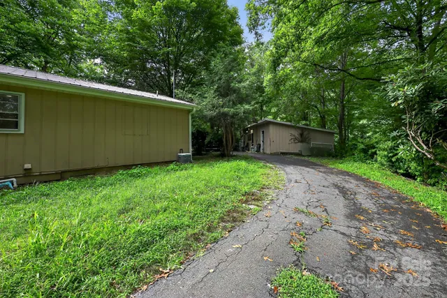 a view of a backyard with large trees