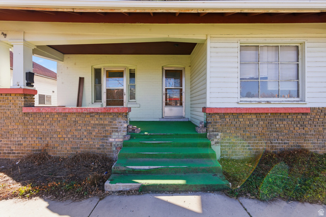 869 West Center Street Provo, UT 84601 - Photo 5 of 32 View of exterior entry featuring covered porch and brick siding