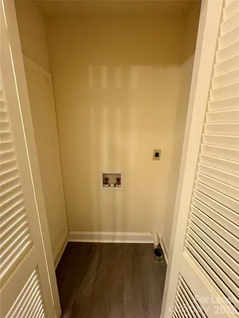 a view of a small space with wooden floor and a balcony