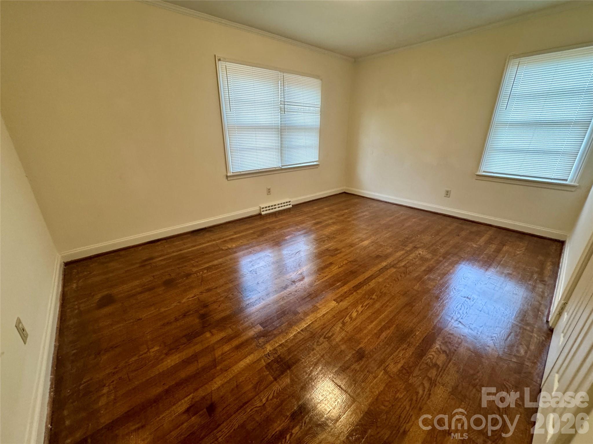 102 Ridge Drive Stanley, NC 28164 - Photo 15 of 18 an empty room with wooden floor and windows