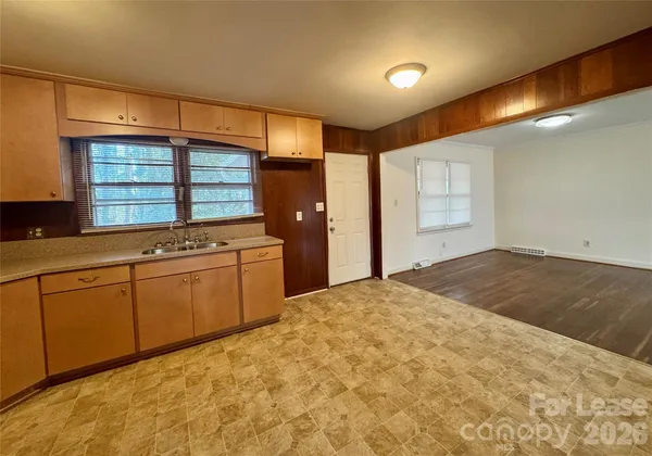 a kitchen with granite countertop a sink and cabinets