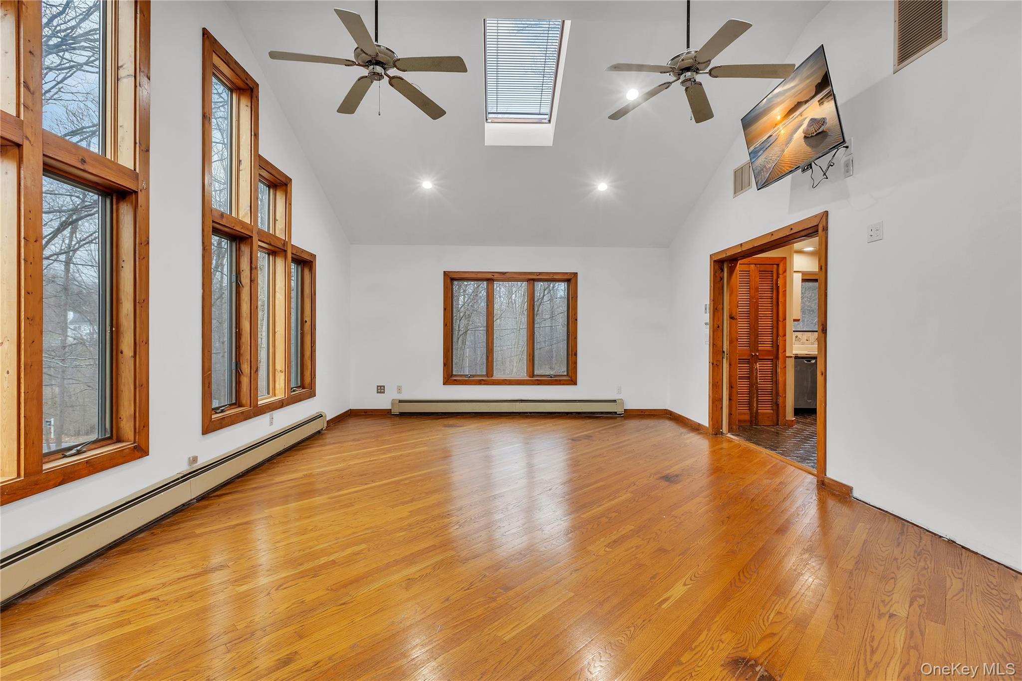 1845 Jacob Road Cortlandt Manor, NY 10567 - Photo 11 of 38 an empty room with wooden floor and windows
