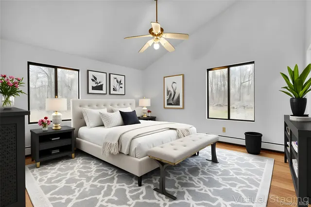 a spacious bedroom with a bed and a window