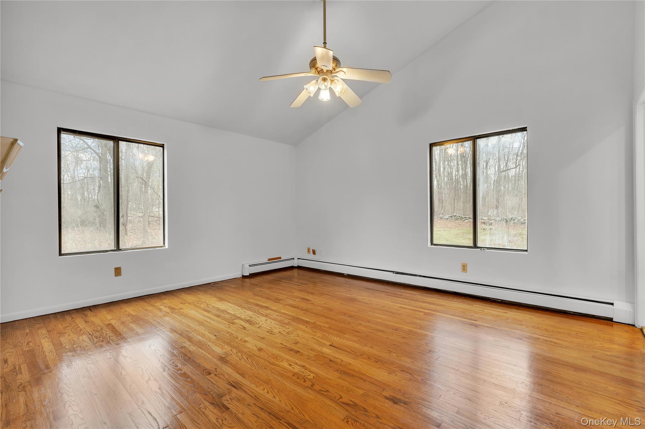 1845 Jacob Road Cortlandt Manor, NY 10567 - Photo 15 of 38 a view of an empty room with wooden floor and a window