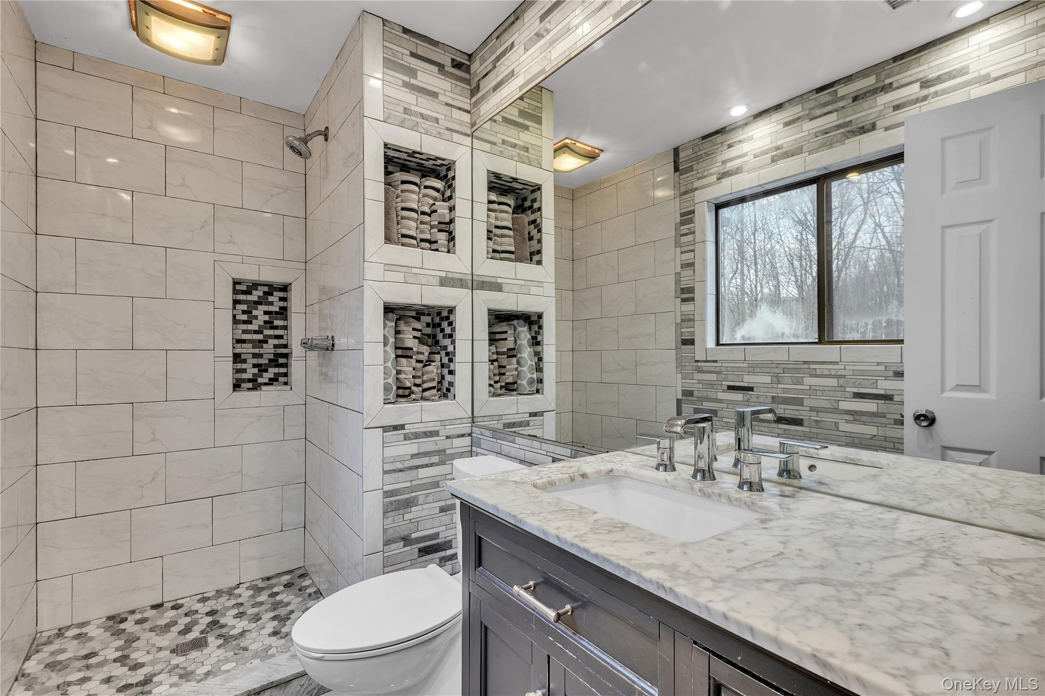 1845 Jacob Road Cortlandt Manor, NY 10567 - Photo 17 of 38 a bathroom with a granite countertop sink a toilet and shower