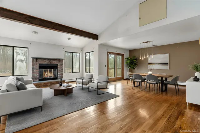 a living room with fireplace furniture and a wooden floor