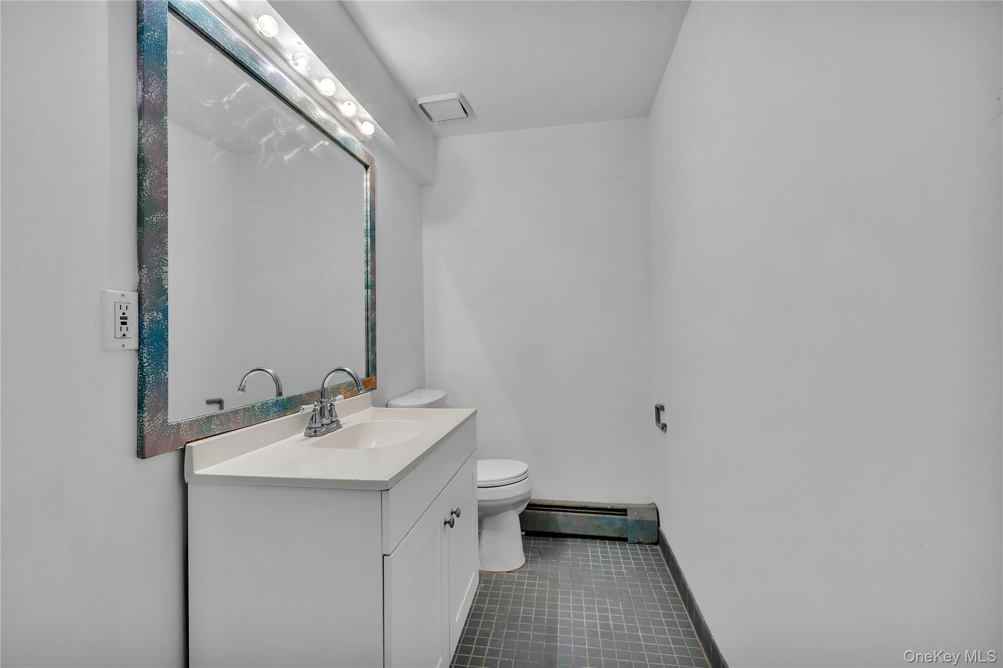 1845 Jacob Road Cortlandt Manor, NY 10567 - Photo 30 of 38 a bathroom with a sink mirror and toilet