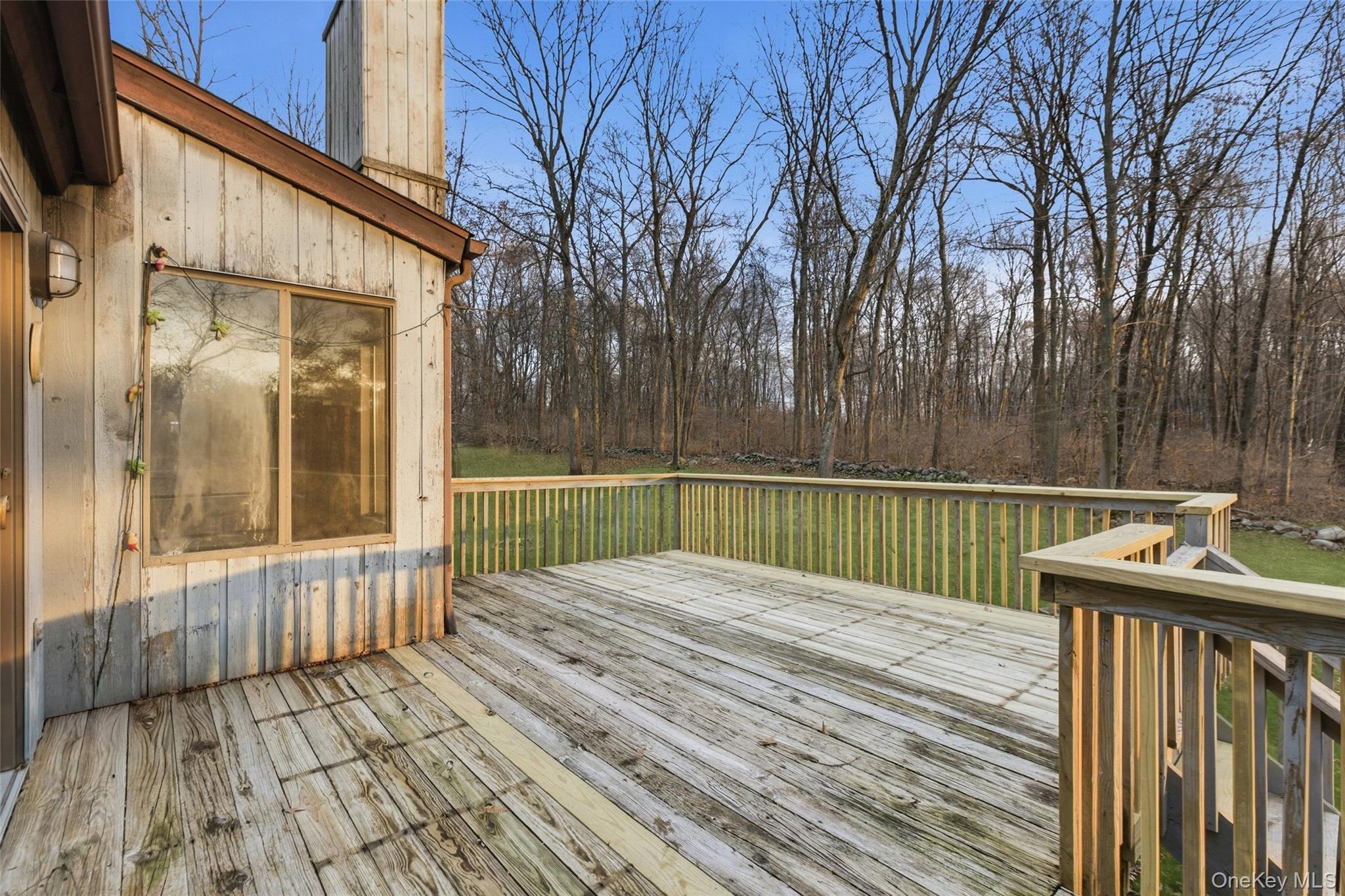 1845 Jacob Road Cortlandt Manor, NY 10567 - Photo 32 of 38 a view of deck with wooden floor and outdoor seating