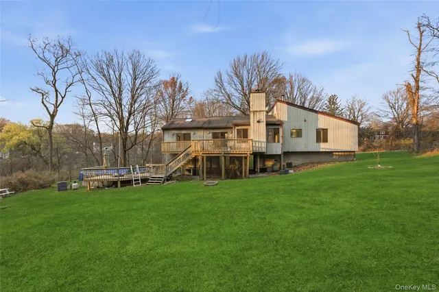 a view of a house with a yard and sitting area
