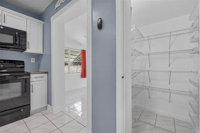 a view of a kitchen with electric appliances