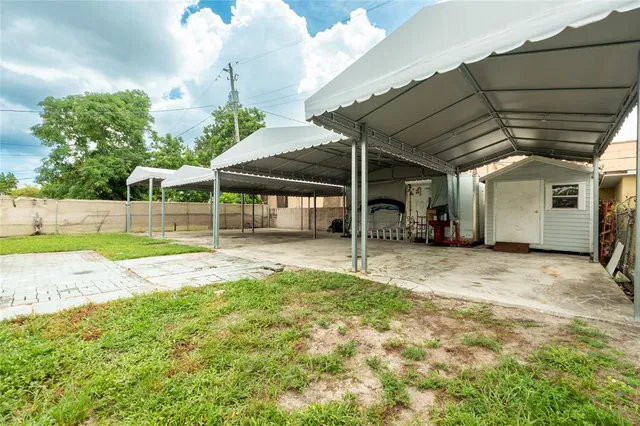 a view of a house with a backyard and a small cabin
