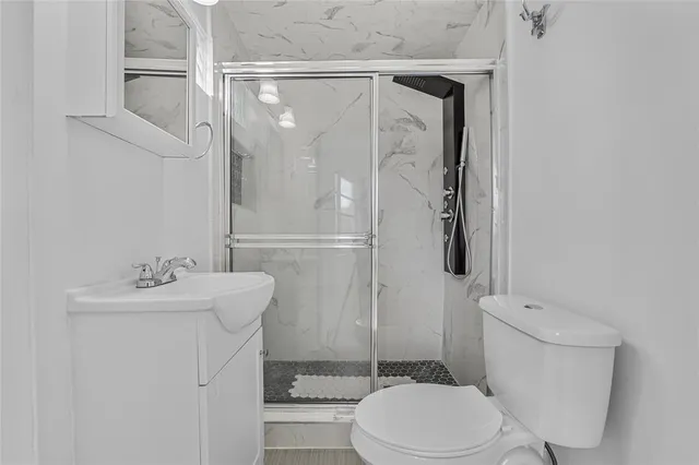 a bathroom with a sink toilet and shower