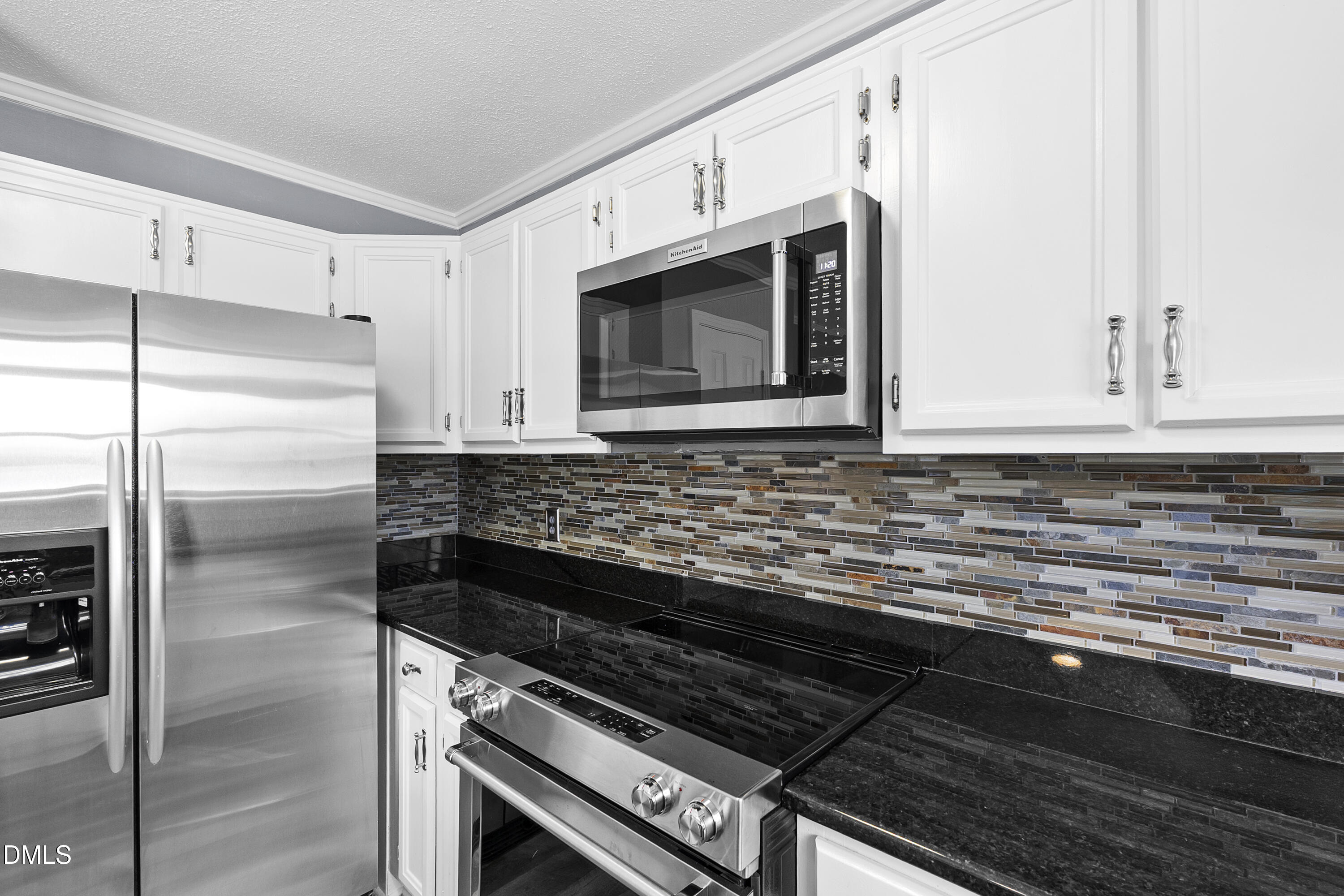 1821 Owls Nest Road Sanford, NC 27330 - Photo 40 of 77 a kitchen with granite countertop a stove microwave and refrigerator