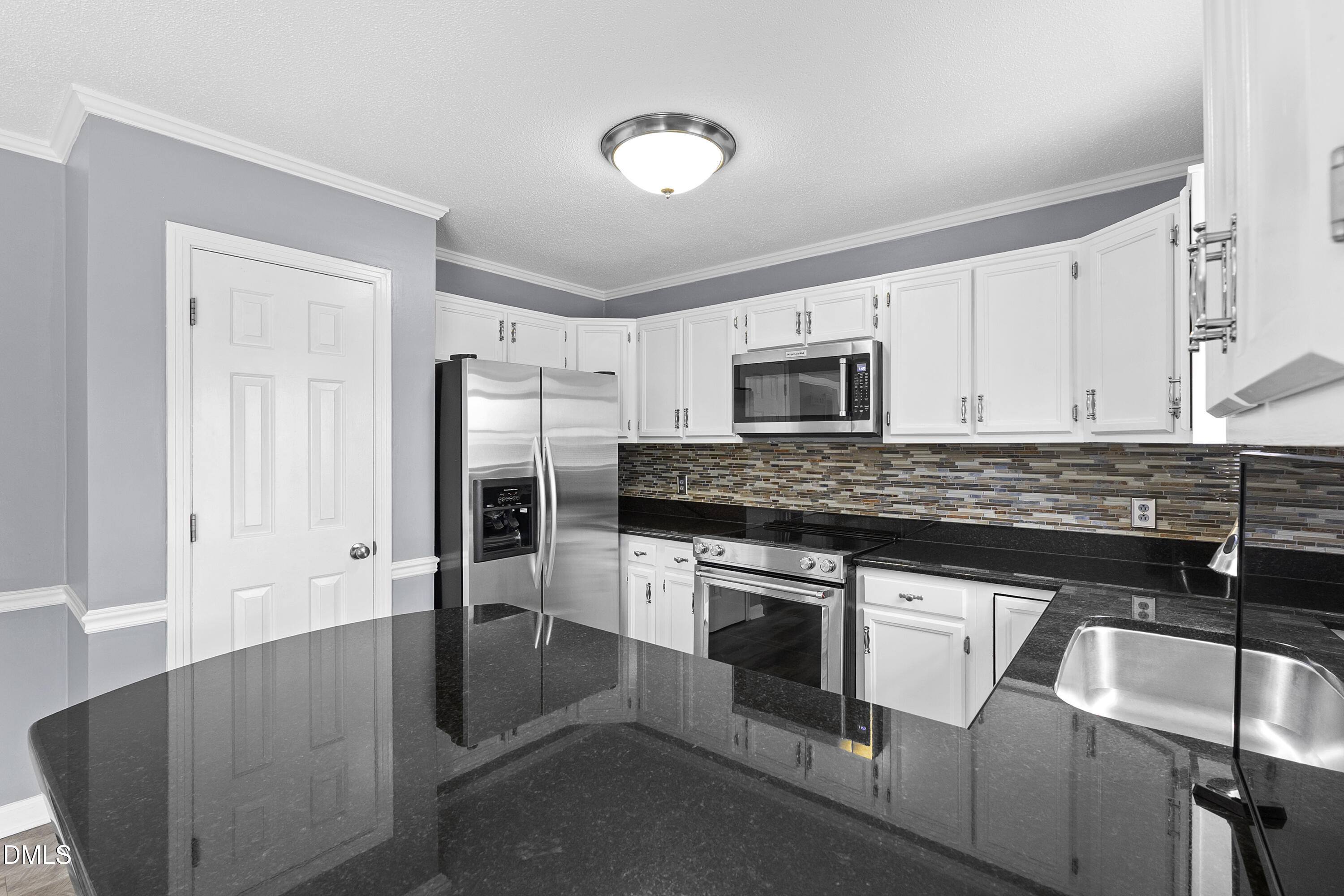 1821 Owls Nest Road Sanford, NC 27330 - Photo 41 of 77 a kitchen with granite countertop a stove and a sink