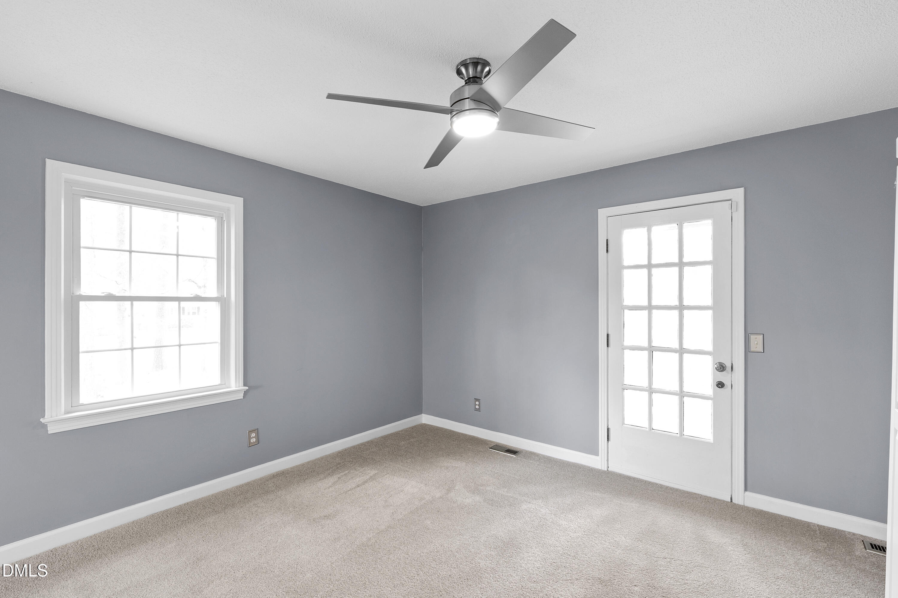 1821 Owls Nest Road Sanford, NC 27330 - Photo 52 of 77 an empty room with windows and fan