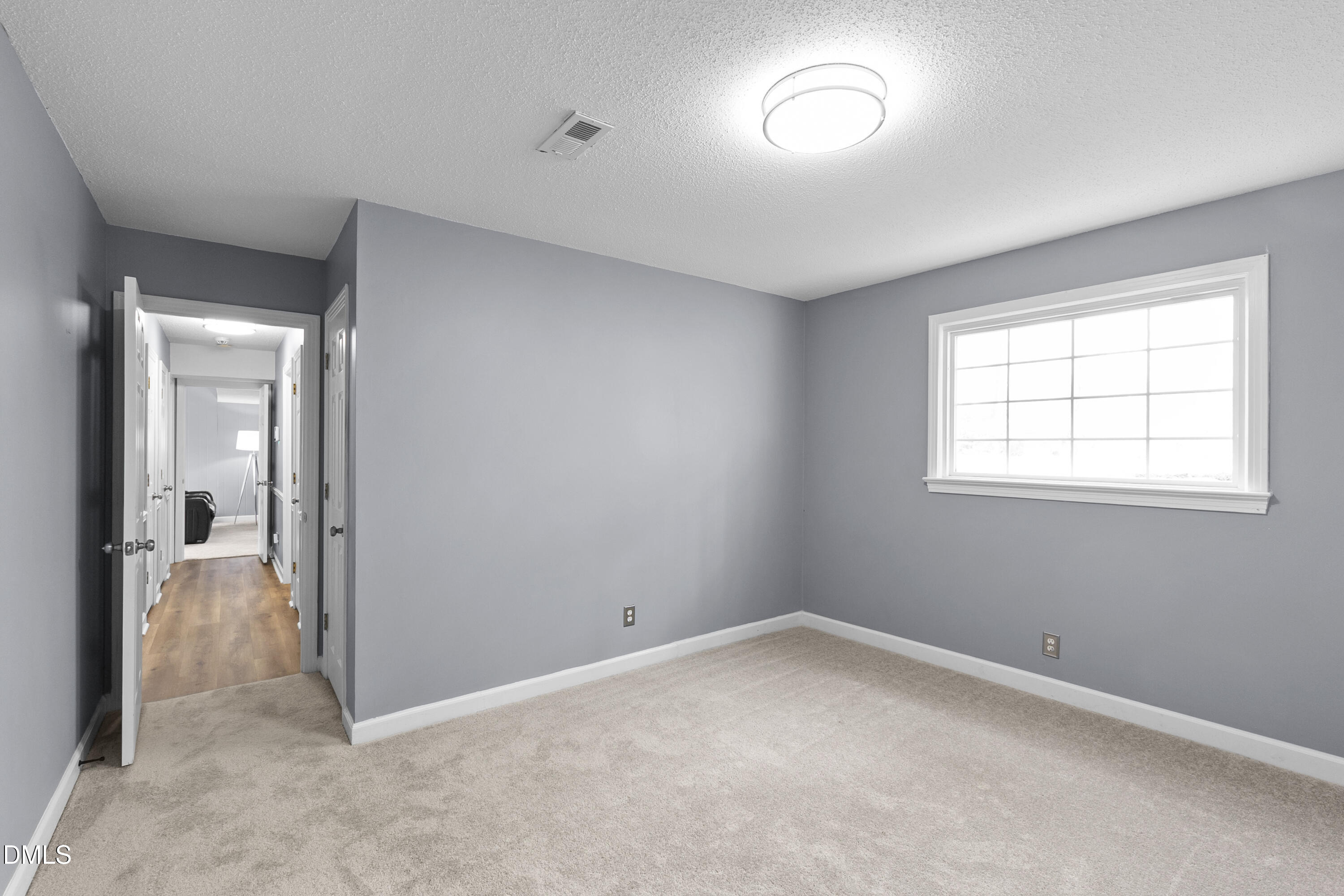 1821 Owls Nest Road Sanford, NC 27330 - Photo 57 of 77 an empty room with a window and a mirror