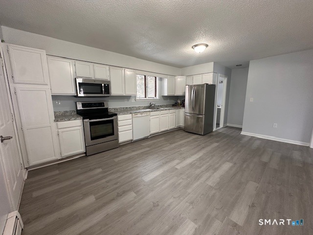 a kitchen with a refrigerator and a stove top oven
